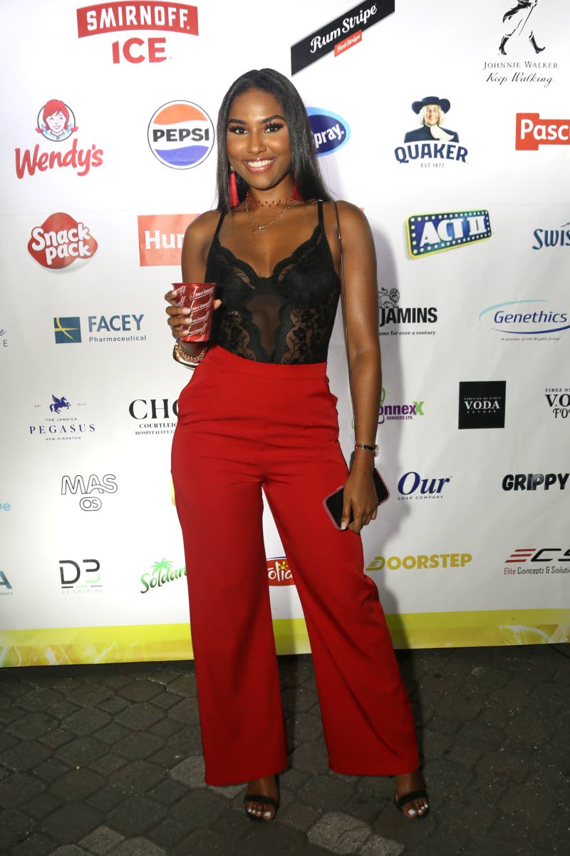 Miss Jamaica World 2022 Shanique Singh stuns in a lace bodice and tailored, red trousers.