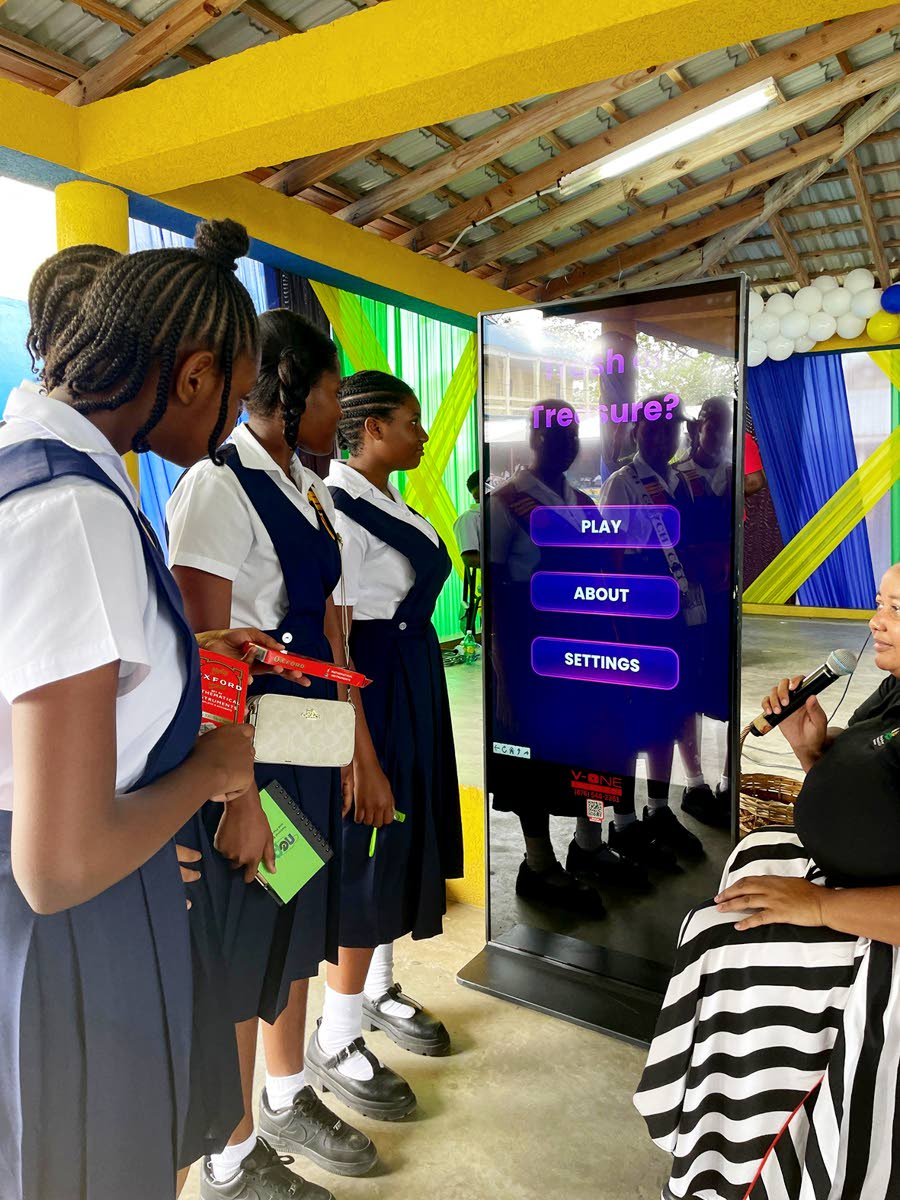 Students from St Thomas Technical High School engage with newly launched NEPA educational games during the National School Environmental Club Programme Workshop, guided by Senior Public Education and Community Outreach Officer, Ava Tomlinson.