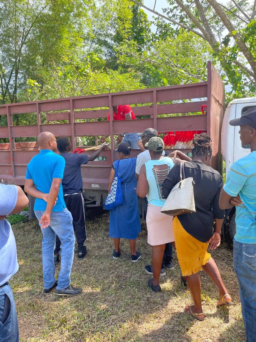 Farmers wait in line to collect supplies at the ‘Farmers’ Pop-Up’ initiative organised by Christopher Brown, member of parliament for St Mary South Eastern, on Wednesday.