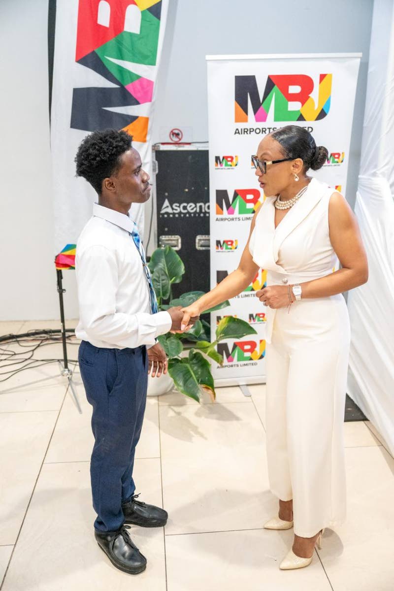 Sharon Heslop-Holt, manager of commercial business development and marketing at MBJ Airports Limited, greets Damario Hutchinson, one of the tertiary beneficiaries of the MBJ Foundation Charity Run/Walk Grant.