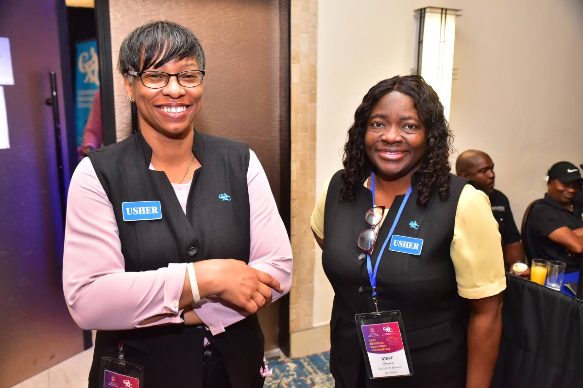 CXC staff Arana Thompson (left) and Sharon Cameron-Brown pose for a photograph.