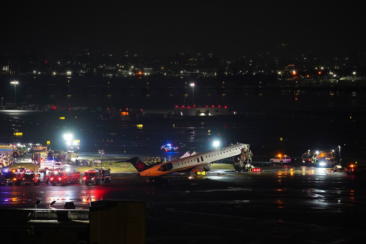 An Air Canada Jet sits on the runway at LaGuardia Airport on March 23, 2026, after colliding with a Port Authority aircraft rescue and firefighting vehicle in New York. (AP Photo/Ryan Murphy)
