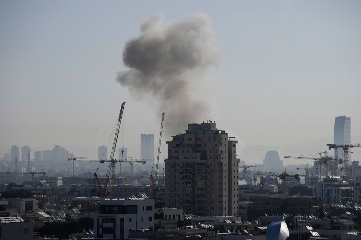 Smoke billows following an Iranian missile strike in Tel Aviv on March 24, 2026. (AP Photo/Ohad Zwigenberg)