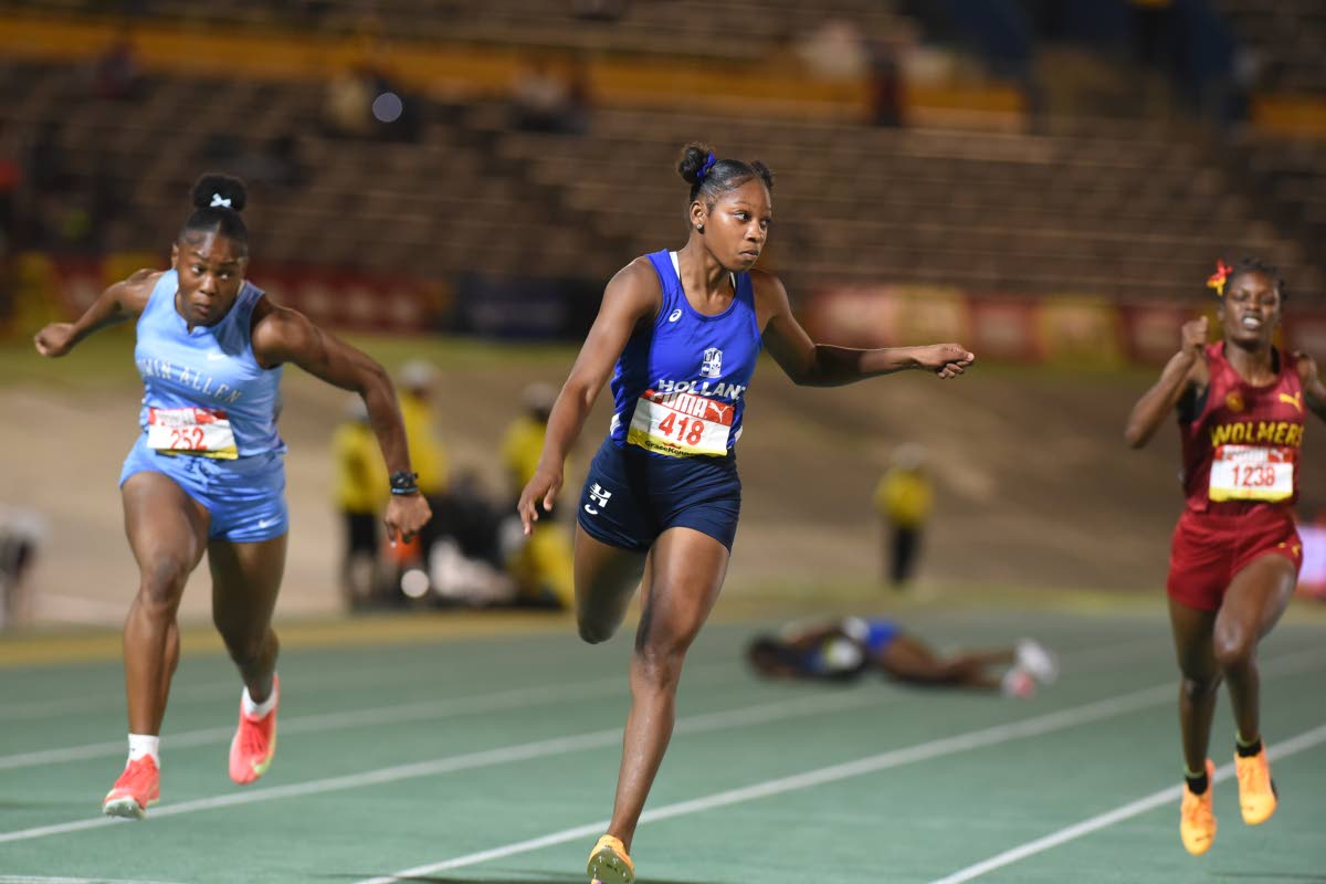 Holland High School’s Shanoya Douglas dips below 11 seconds to win the Girls’ Class 1 100 metres at the ISSA/GraceKennedy Boys and Girls’ Athletics Championships inside the National Stadium yesterday.
