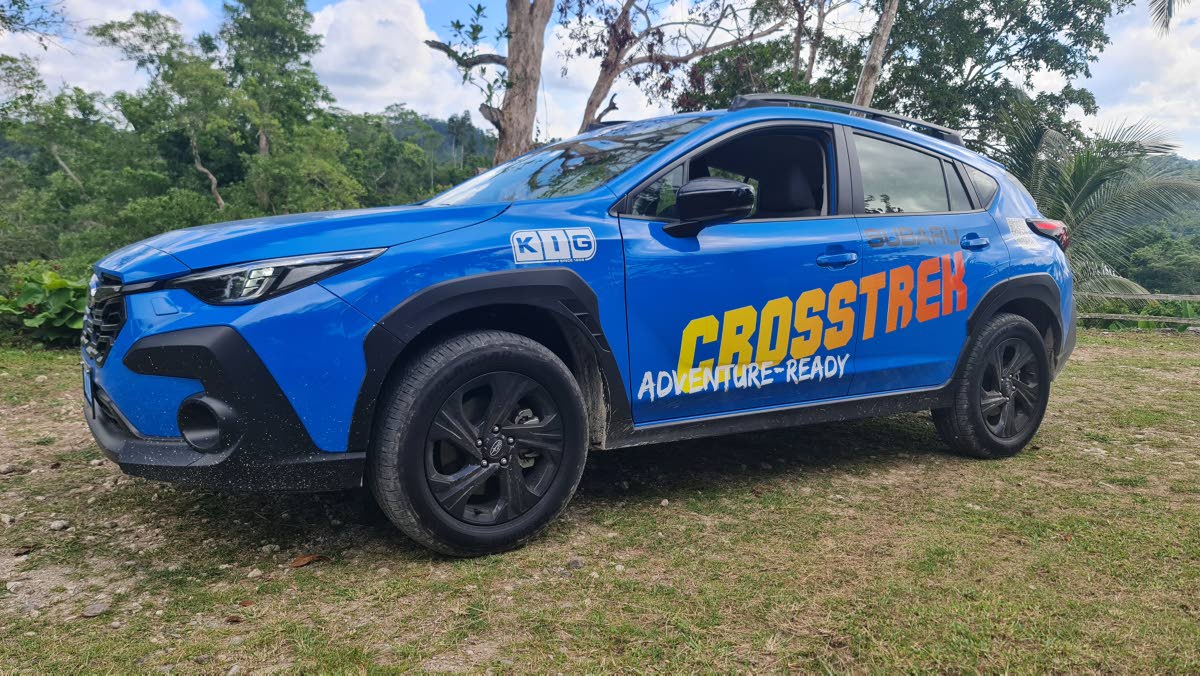 The profile view reveals how the 8.7 inches of ground clearance and protective lower cladding distinguish this chassis from its hatchback roots, emphasising its readiness for unpaved terrain.