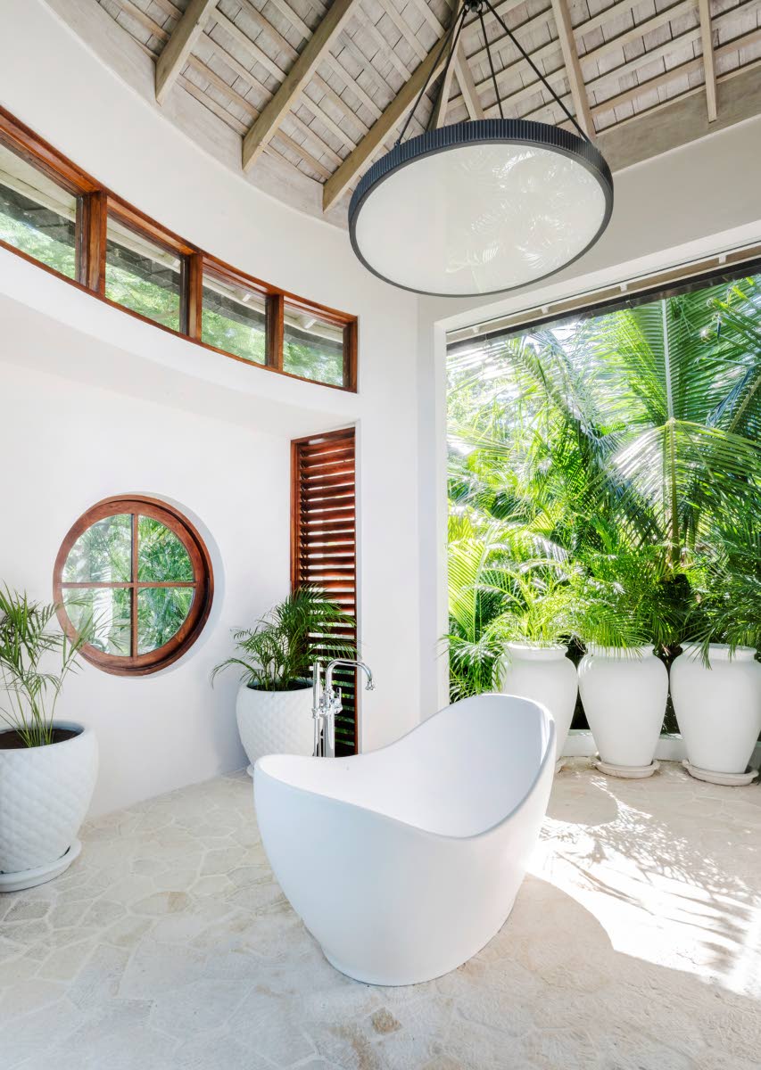 A bathroom, with a soaking tub, is part of the outdoors.