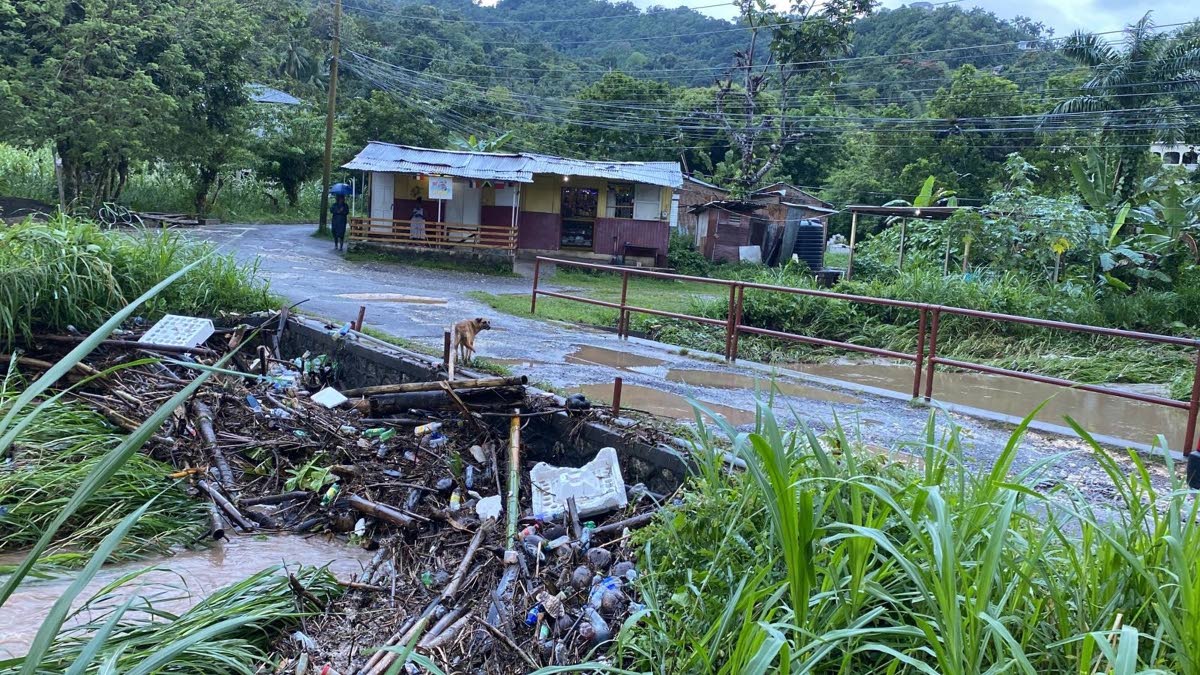 Debris block the waterway at this bridge along the Seaview Farm Road in Portland on Saturday. The blockage resulted in the river overflowing its banks, sending water into nearby homes.