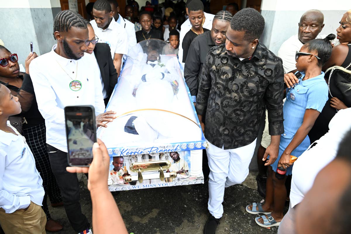 Pall-bearers with the coffin containing the body of Kiero Pinnock during his funeral yesterday at the Regent Street Seventh-day Adventist Church in Kingston. 