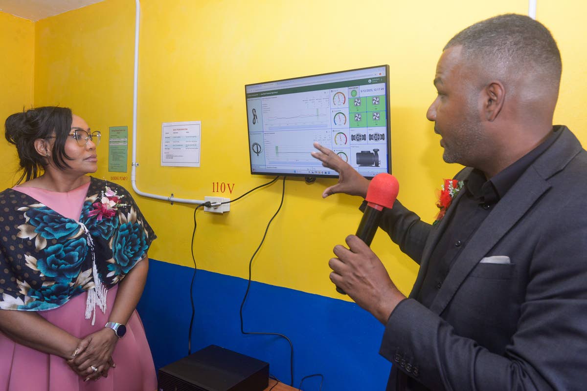 Senior Education Officer at the Ministry of Education, Skills, Youth and Information, Okemo Dukie (right), in discussion with Technical Support Officer at the Ministry, Dr Nahema Daniels-Heath, during the recent handover ceremony for a state-of-the-art sma
