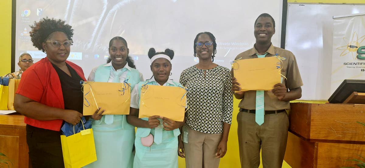Lister Mair Gilby High School for the Deaf teacher Tainia Taylor (left) shares a photo with students Gabriel Jones, Keonah Macko and Tariq Ferguson, along with their STEM role model Dr Ainka Brown (second right), a lecturer in the Chemistry Department at t