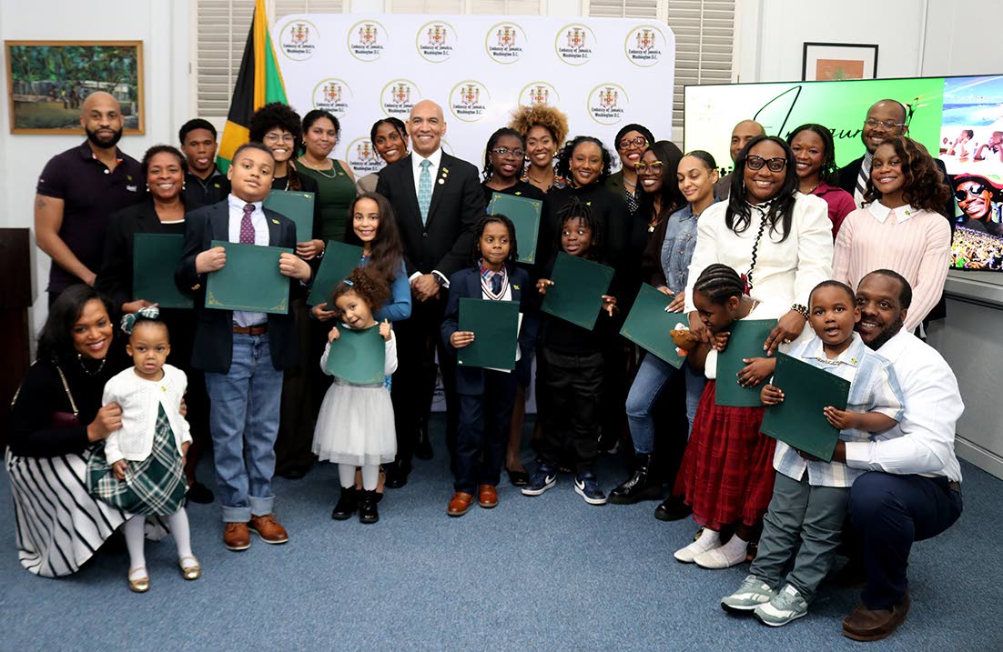Jamaica’s Ambassador to the United States, Major General (Ret’d) Antony Anderson (centre) shares a celebratory moment with 27 newly naturalised Jamaican citizens after he presented each with an official letter of recognition. 