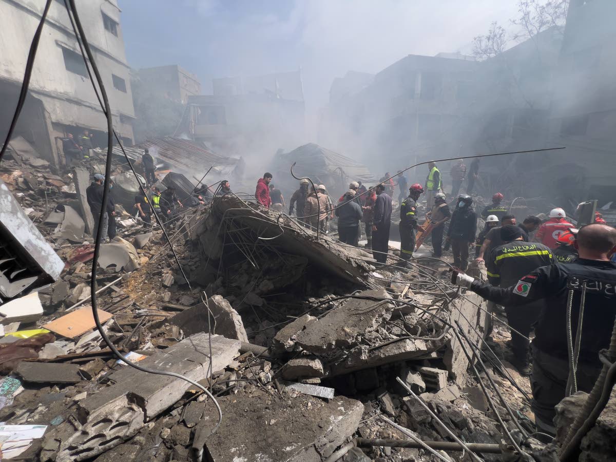 Rescue workers search for victims at the site of an Israeli airstrike that hit a crowded neighbourhood south of Beirut, Lebanon, Sunday, April 5, 2026. 