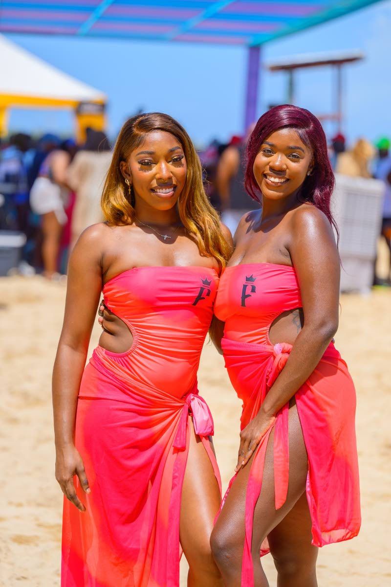 Frenchmen hostesses Ishena Hylton (left) and Aliya Johnson turn heads in coordinated coral looks.
