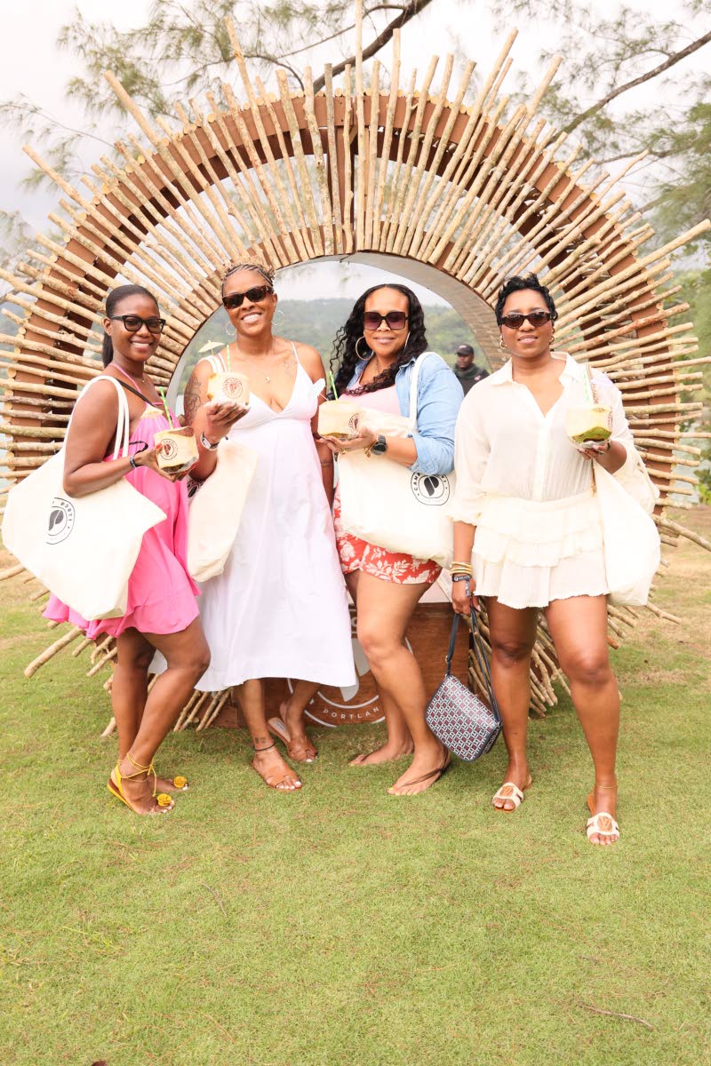 Checking in for Porti Village with their welcome bags and coconuts in hand are (from left) Attorney Kelisha Shaw; Medical Office Assistant Trisha Edwards; Principal Moneque McKoy; and Software Engineer Manager Lackeisha Lewis.