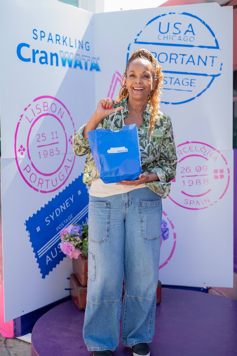 Miss Universe 1977 Janelle Commissiong of Trinidad and Tobago is all smiles at the Sparkling CranWATA photo booth.