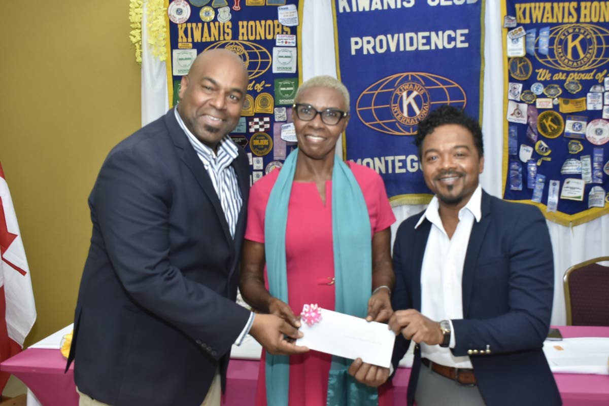 Dr Garfield Badal (right), a consultant paediatric surgeon at the Cornwall Regional Hospital, collects a cheque from Dwight Crawford, deputy mayor of Montego Bay, and Barbara Grizzle, president of the Kiwanis Club of Providence, Montego Bay, valued at $2.7