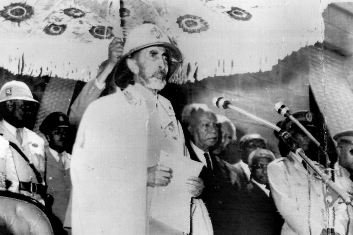 Emperor Haile Selassie I, at microphone.