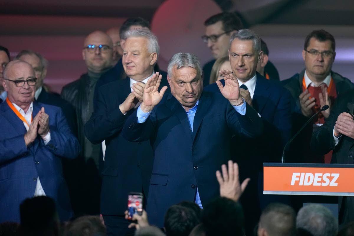 Hungary’s Prime Minister Viktor Orban (centre), flanked by his team, reacts after a parliamentary election in Budapest, Hungary, yesterday. 