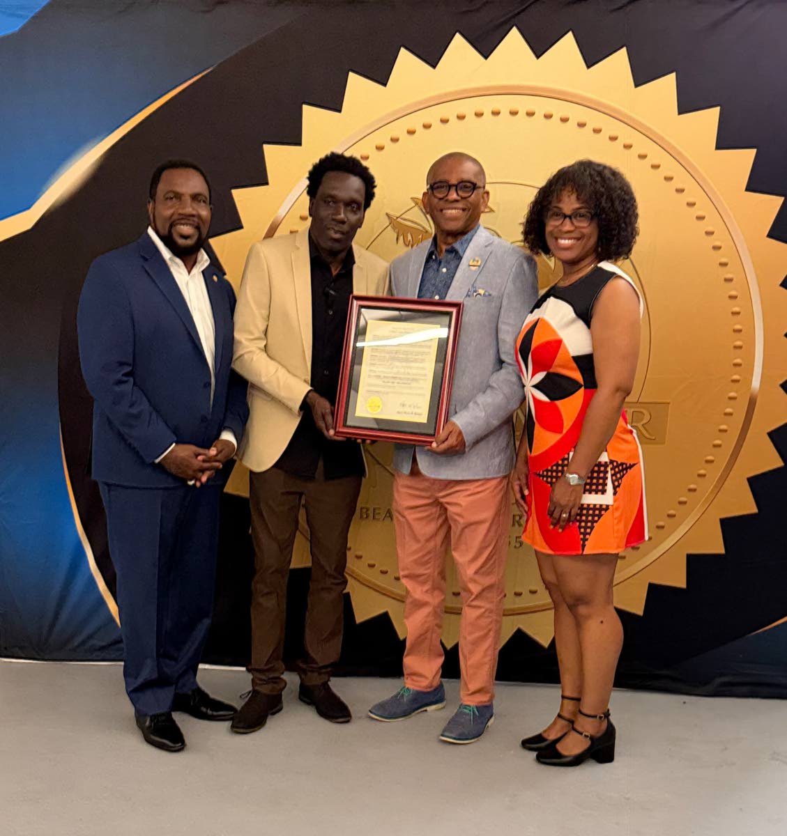Jamaica‑born visual artist Andy Ballentine (second left) poses with his official proclamation alongside Miramar Vice Mayor Eddy Edwards (second right), Commissioners Maxwell B. Chambers (left) and Avril Cherasard last Friday. 