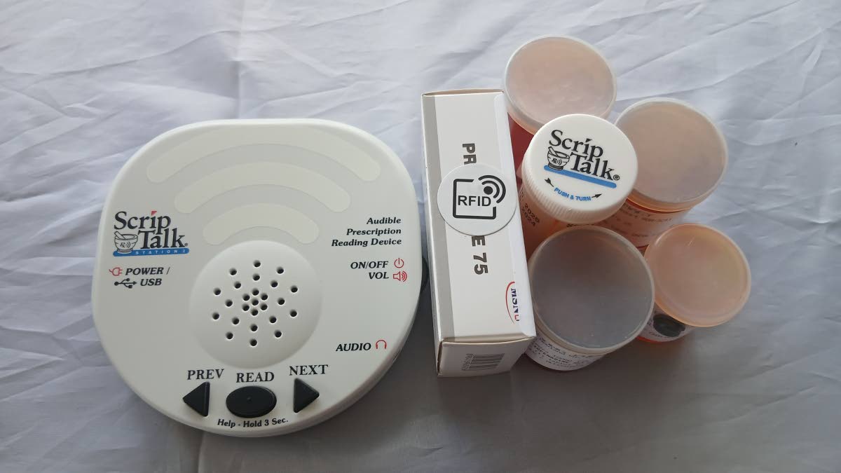 The ScripTalk device and medication containers with the Radio Frequency Identification (RFID) technology tags. The assistive technology reads prescription information aloud, helping persons who are blind, visually impaired, or have reading challenges manag