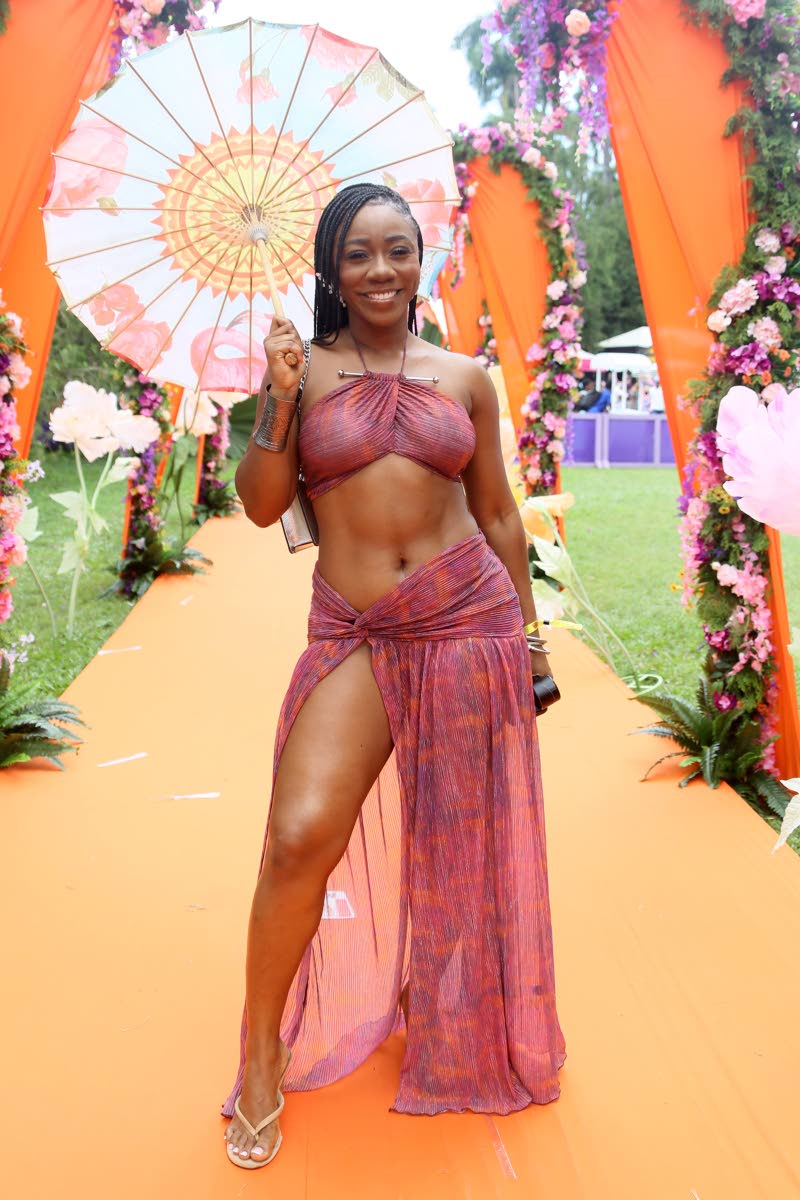 Banker Jonèy Williams banks on bold resort style in a tie-dye halter and high-slit skirt.