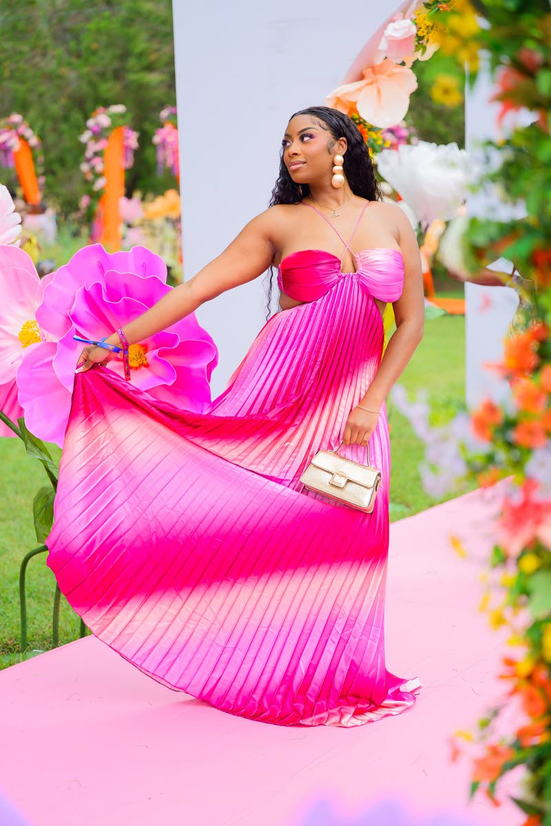 Event planner Gen Love lights up the party in a flowing, pleated maxi. 