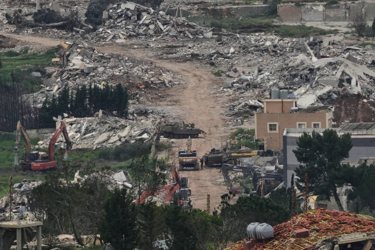 Israeli army vehicles and bulldozers operate in southern Lebanon, as seen from northern Israel, Wednesday, April 15, 2026. 