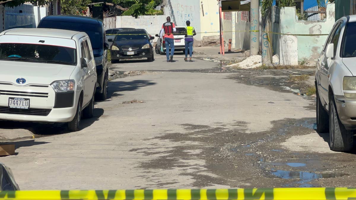 INDECOM and police personnel carry out investigations along Stephen Lane. 