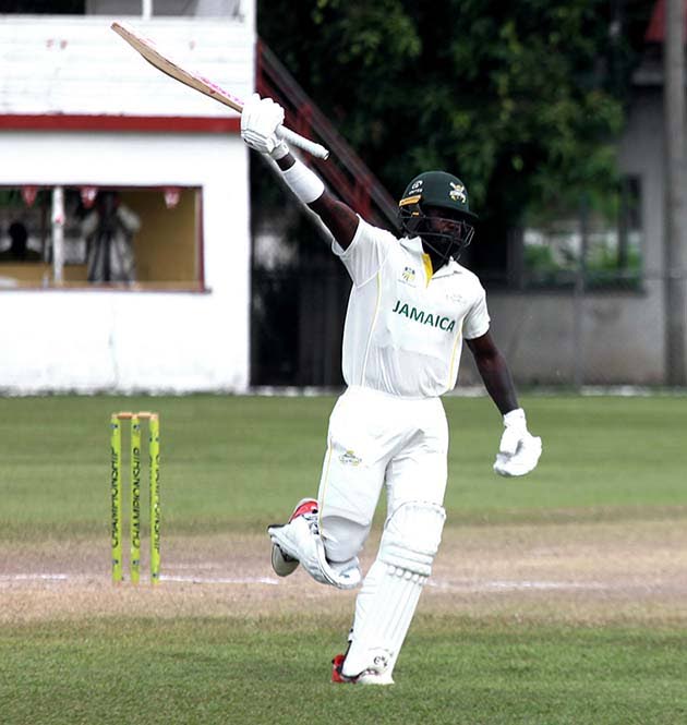 Jamaica Scorpions’ Kirk McKenzie Jr celebrates scoring a century on the fourth day of the West Indies Championship cricket match against Barbados Pride at Chedwin Park, St Catherine, yesterday.