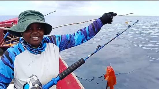 Female fisher Sashae Shaw catches fish on the high seas in Portland recently. 