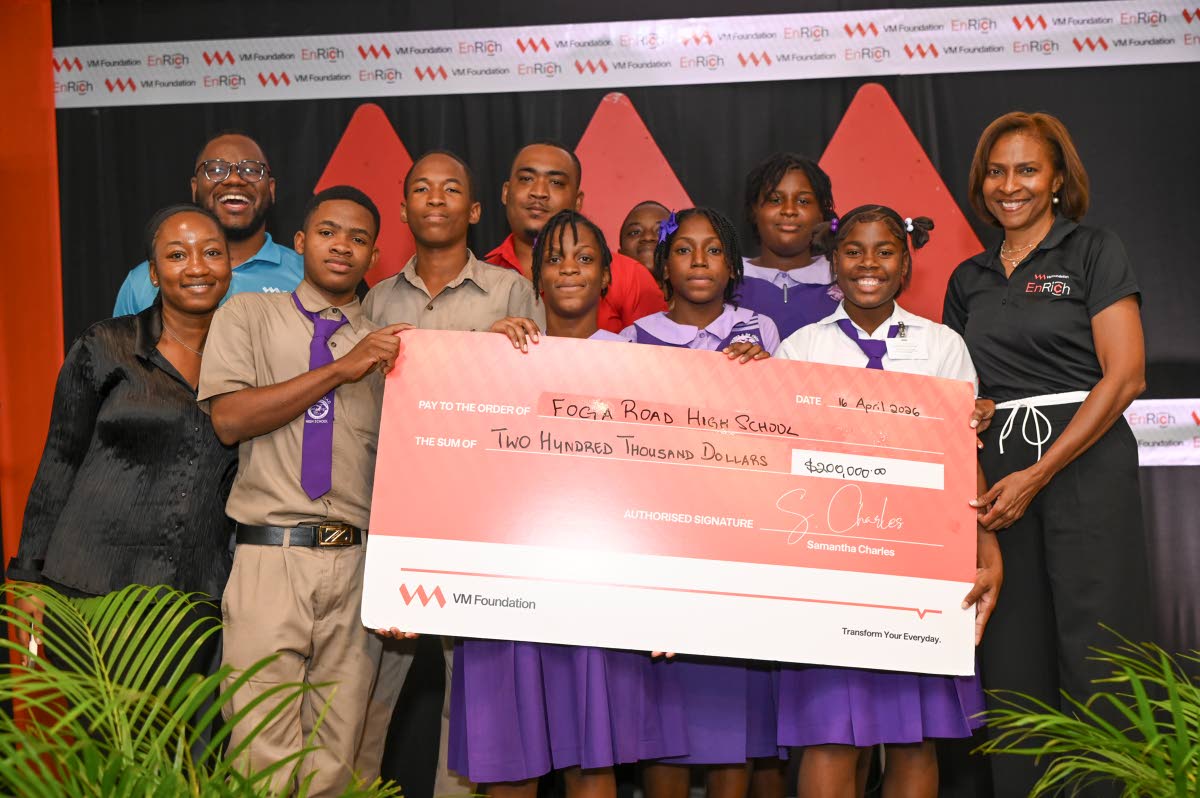 Foga Road High School collects their symbolic cheque from Samantha Charles (right), CEO of the VM Foundation, at the end of the pitch competition. At left (back) is Andre Robb, programme lead, VM Foundation. 