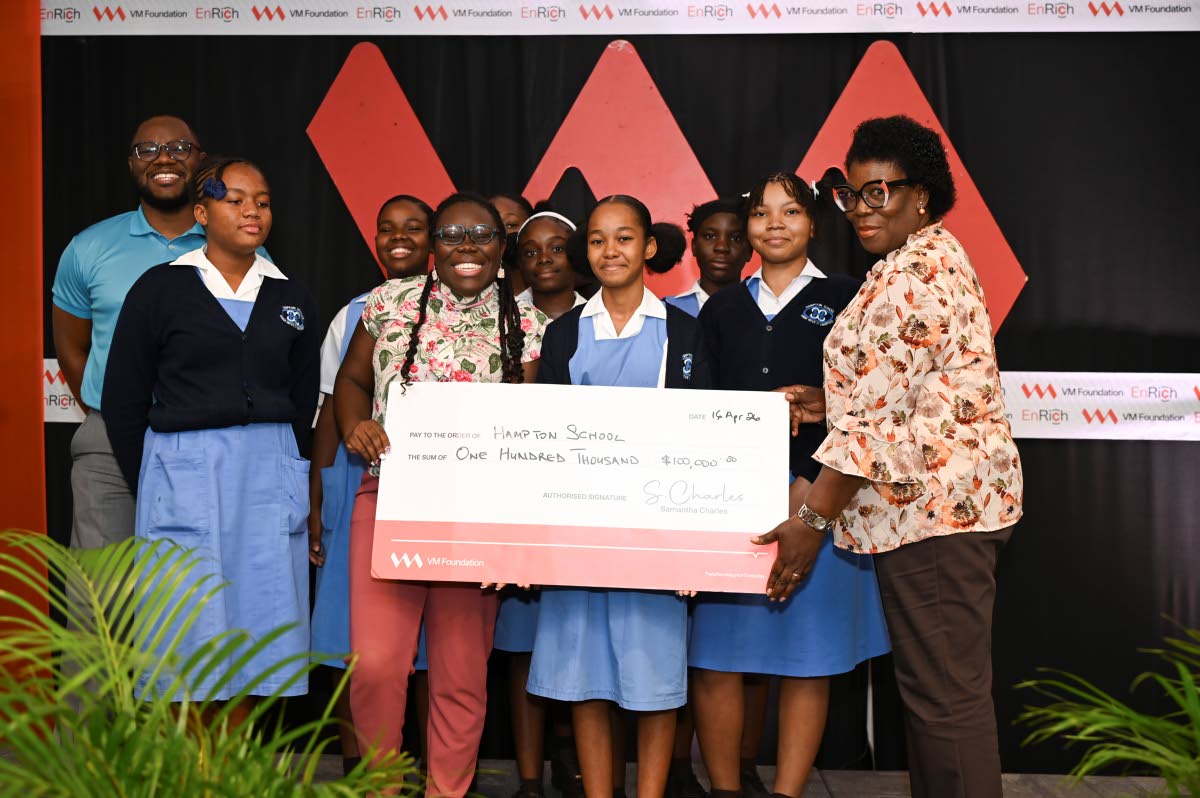 Hampton School collects their symbolic cheque from Dr Lorna Gow-Morrison (right), member of the Board of Directors of the VM Foundation, at the end of the pitch competition. On the left (back) is Andre Robb, programme lead, VM Foundation. 
