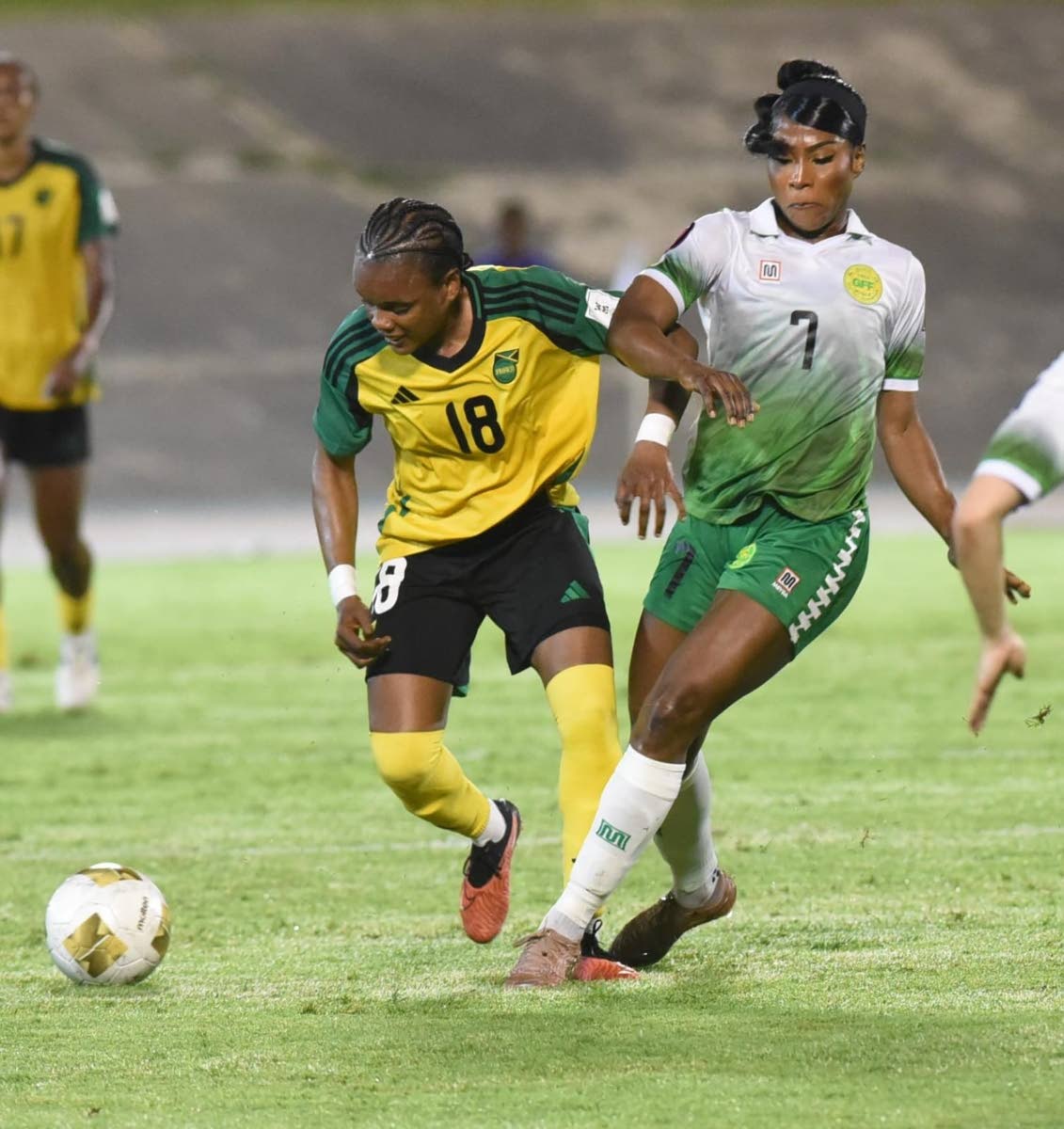 
Reggae Girlz attacker, Trudi Carter tries to escape the attentions of Guyana’s Otesha Charles during their Concacaf W Qualifier inside the National Stadium yesterday.