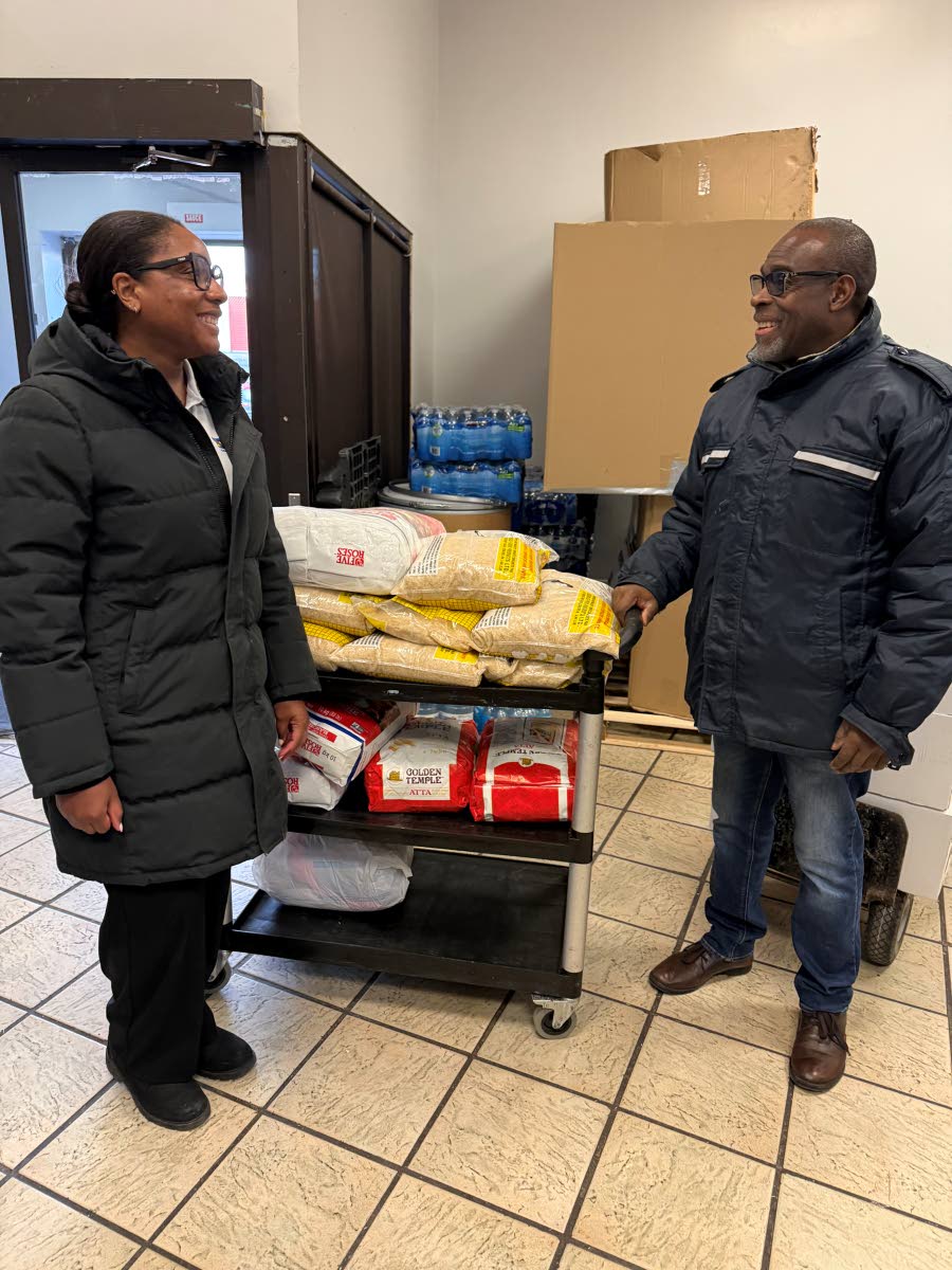 Broughton (left) in conversation with David Betty, president of the Jamaican Canadian Association in Ontario at a Hurricane Melissa donation relief drop-off centre last November. JN Bank in Canada served as the official drop-off for items collected in Toro