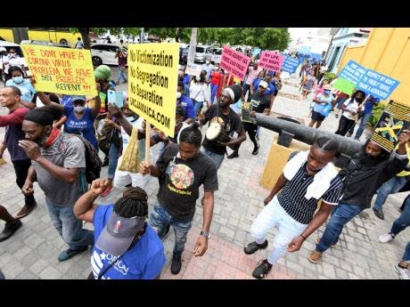 Protesters proceed on their march from North Parade in downtown Kingston towards Gordon House in defiance of instructions from the police not to proceed with the unauthorised event on September 22, 2021. (Rudolph Brown photo)