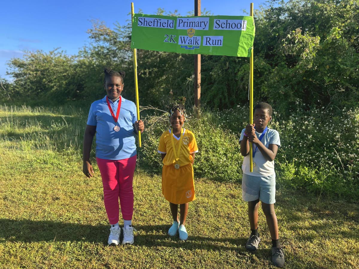 Grade two first‑place finisher Odaaneia Christian (centre), grade‑three second‑place finisher Jadon Thompson (right) and grade‑five student Kayandra Kerr (left), who placed third, pose with their medals after the Sheffield Primary 2K walk/run on Fr