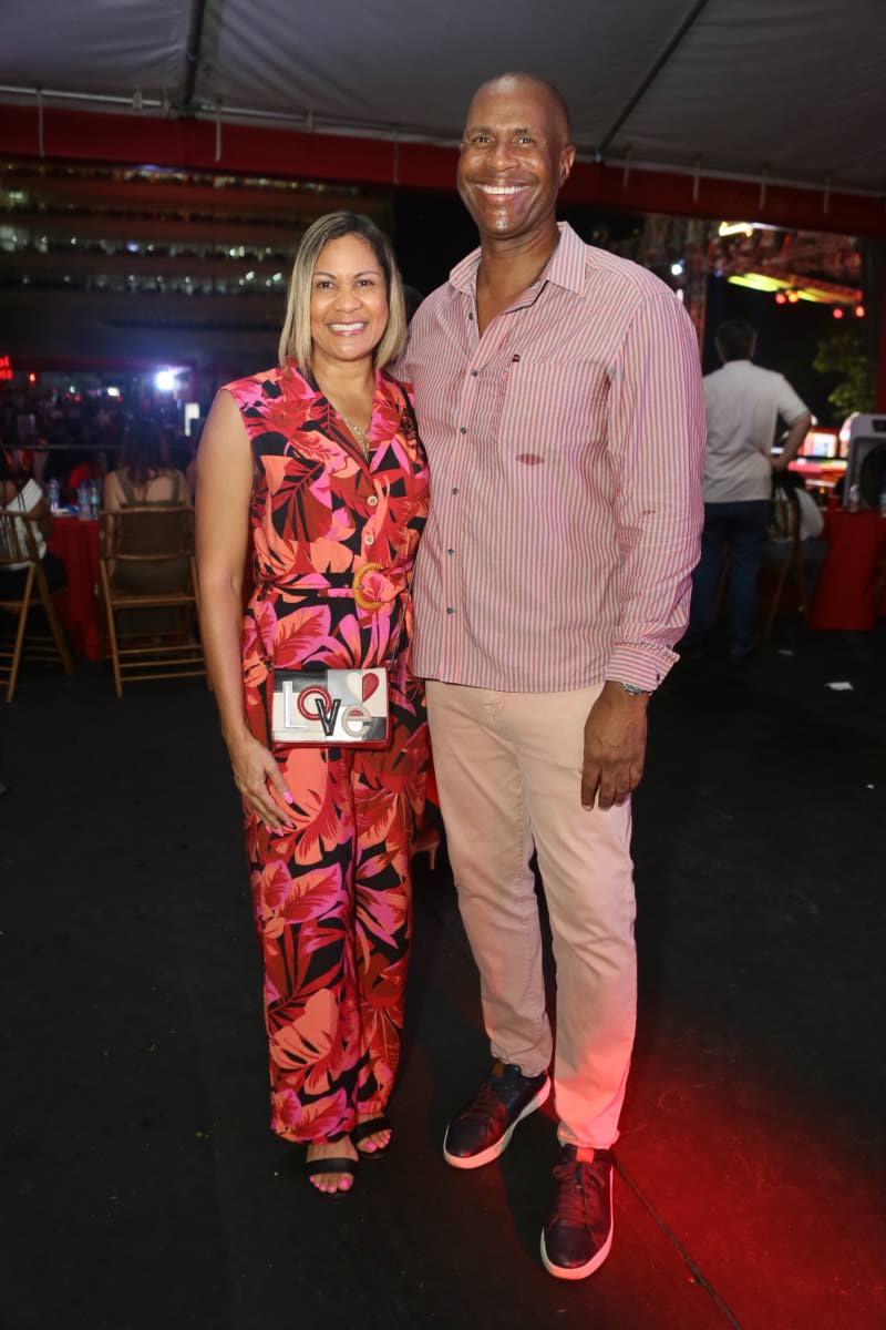 Bruce James, president and co-founder of MVP Track & Field Club, pairs up with financial executive Leesa Kow for a photo opportunity.