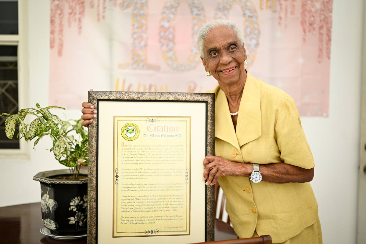 Dr Mavis Gilmour-Petersen displays a citation from the ministry during a visit to her St Andrew home on April 16.