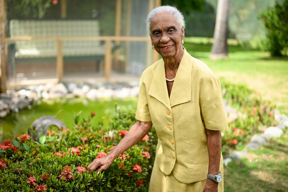Dr Mavis Gilmour-Petersen poses in her garden at her St Andrew home on April 16.