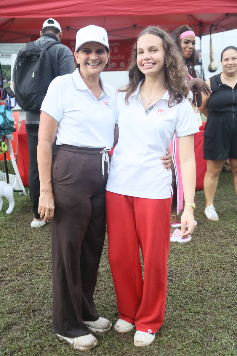 The mother-daughter duo of Happy Tails, Melissa (left) and Milena Esliger, take a break from a busy Yappy Hour to smile for our lens.