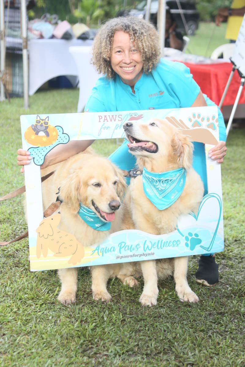 Dr Bernadette Bryan-Frankson, canine rehabilitation therapist and owner of Paws for Physio, gets the Esligers’ golden retriever sisters, Alba and Misty (right), in frame for a ‘paw-fect’ picture moment.