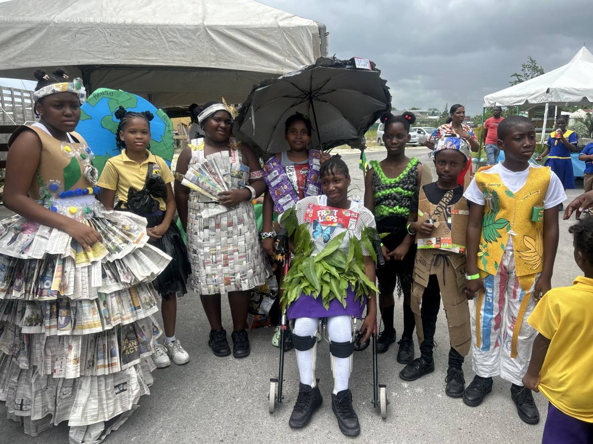 From left: Jaylee Anderson, Leandra Beckford, Jada Brown, Selena Brissett, Deborah Brown, Arianna Clarke (front), Nathan Williams, and Shamar Sicard, all grade five students, proudly display outfits made from recycled materials during Ecofest 2026.