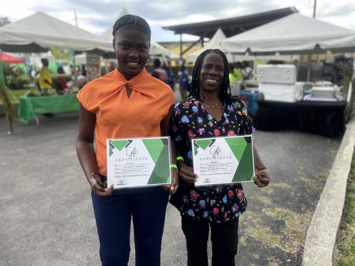 Raffle winners Kadian Hall, (left) , grade four teacher, and Pauline Henry, school custodian.