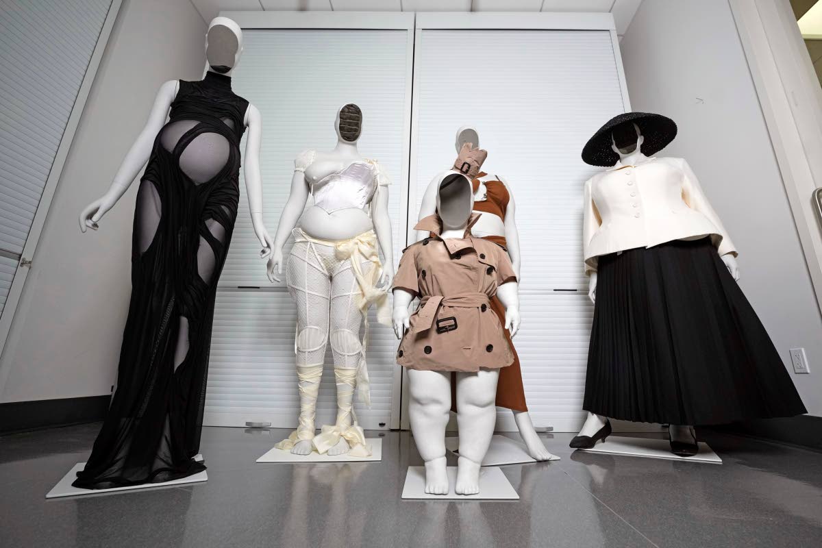 From left: A Di Petsa dress by designer Dimitra Petsa appears on a pregnant mannequin, an ensemble by Michaela Stark on a mannequin in Stark's image, a Burberry ensemble by Christopher Bailey on a mannequin image of Sinéad Burke (foreground), an ensemble 