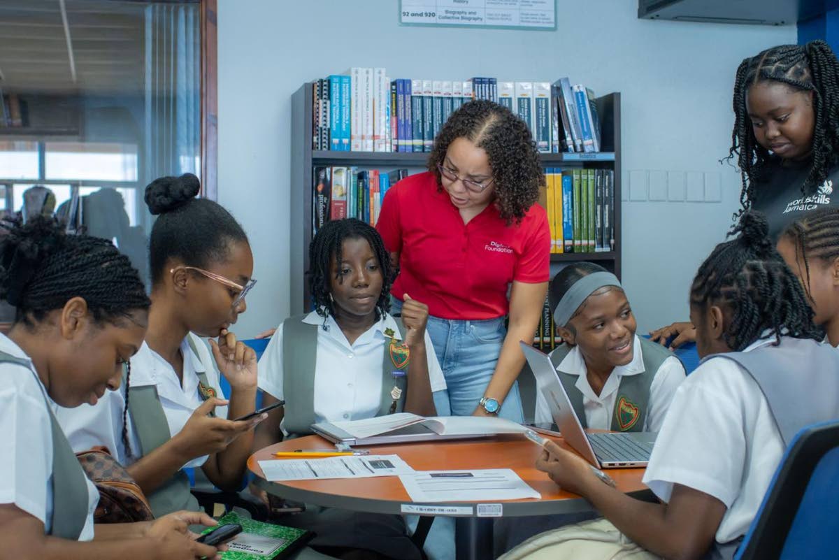 Avryl Francis, Digicel Foundation board director and security operations manager, engages with participants during the Girls in ICT Day AI and Climate Change Hackathon on Thursday, hosted by the Digicel Foundation and STEMSpark Solutions.