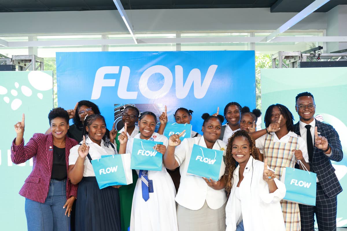 The winning team in Flow’s Girls in ICT Day AI workshop pitch competition celebrates with Maya Walrond (left), senior director, digital transformation, Flow; Rosalynn Williams (second from left), B2B service manager, Flow; Stacey Hines (third from right)