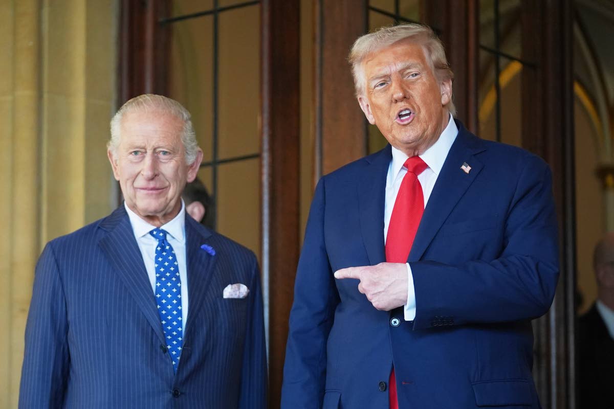 FILE - President Donald Trump gestures next to Britain's King Charles III before leaving Windsor Castle, Windsor, England, Sept. 18, 2025. (AP Photo/Evan Vucci, file)