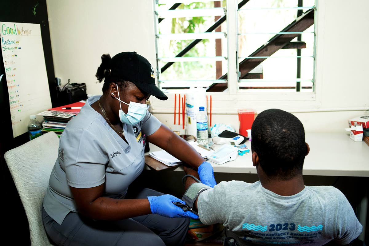 A resident of the Blessed Assurance home for the vulnerable in St James has his vitals checked by a member of the St John Ambulance Jamaica medical team. Funds donated to JN’s ISupportJamaica Fund, are also being used to support medical missions to remot