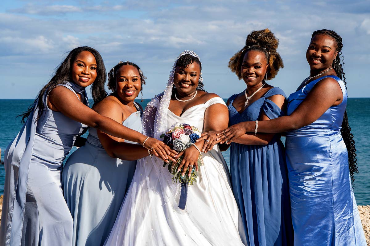 Joining hands to celebrate the bride (centre) are (from left) Ashleigh Hall, Tenea Cadogan, maid of honour; Tashana Boucher, and Ashley Bryan.