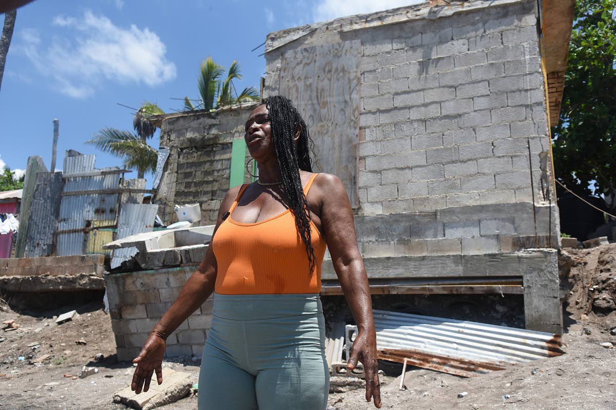 Standing in front of what the sea left of her home, Betty-Ann Brown expains how she has managed to survive the last six months without proper shelter.